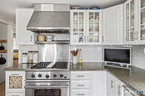 a stove top oven sitting inside of a kitchen