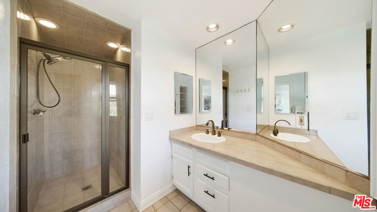 2312 Kimridge Road Beverly Hills, CA 90210 - Photo 50 of 60 a bathroom with a double vanity sink mirror and shower
