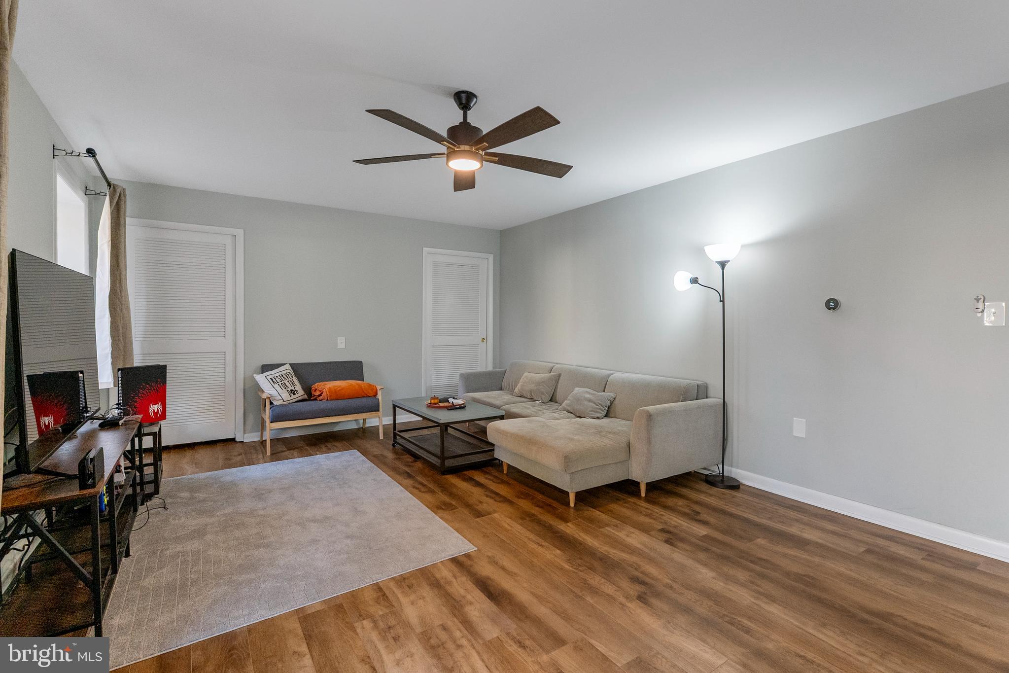 10067 Windstream Drive, Unit 2 Columbia, MD 21044 - Photo 11 of 30 a living room with furniture and a flat screen tv