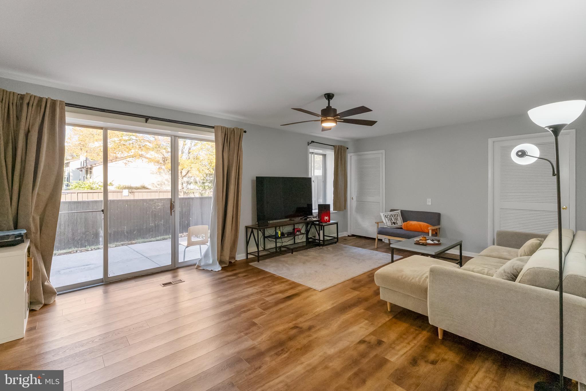 10067 Windstream Drive, Unit 2 Columbia, MD 21044 - Photo 12 of 30 a living room with furniture and a flat screen tv