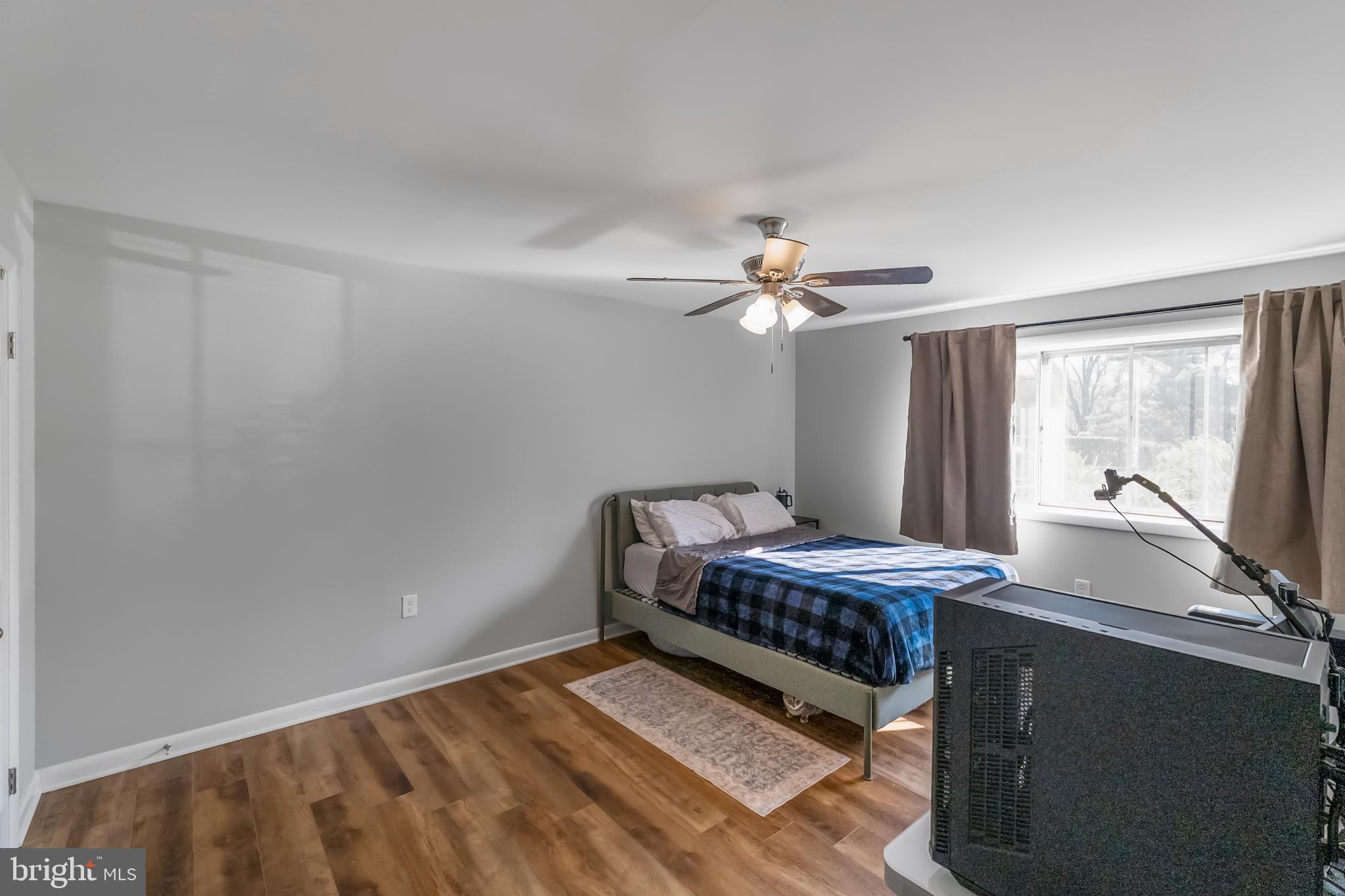 10067 Windstream Drive, Unit 2 Columbia, MD 21044 - Photo 14 of 30 a room with bed and wooden floor