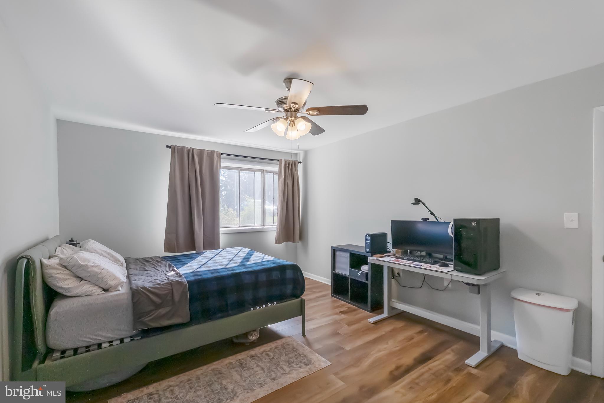 10067 Windstream Drive, Unit 2 Columbia, MD 21044 - Photo 15 of 30 a bedroom with a bed and a television