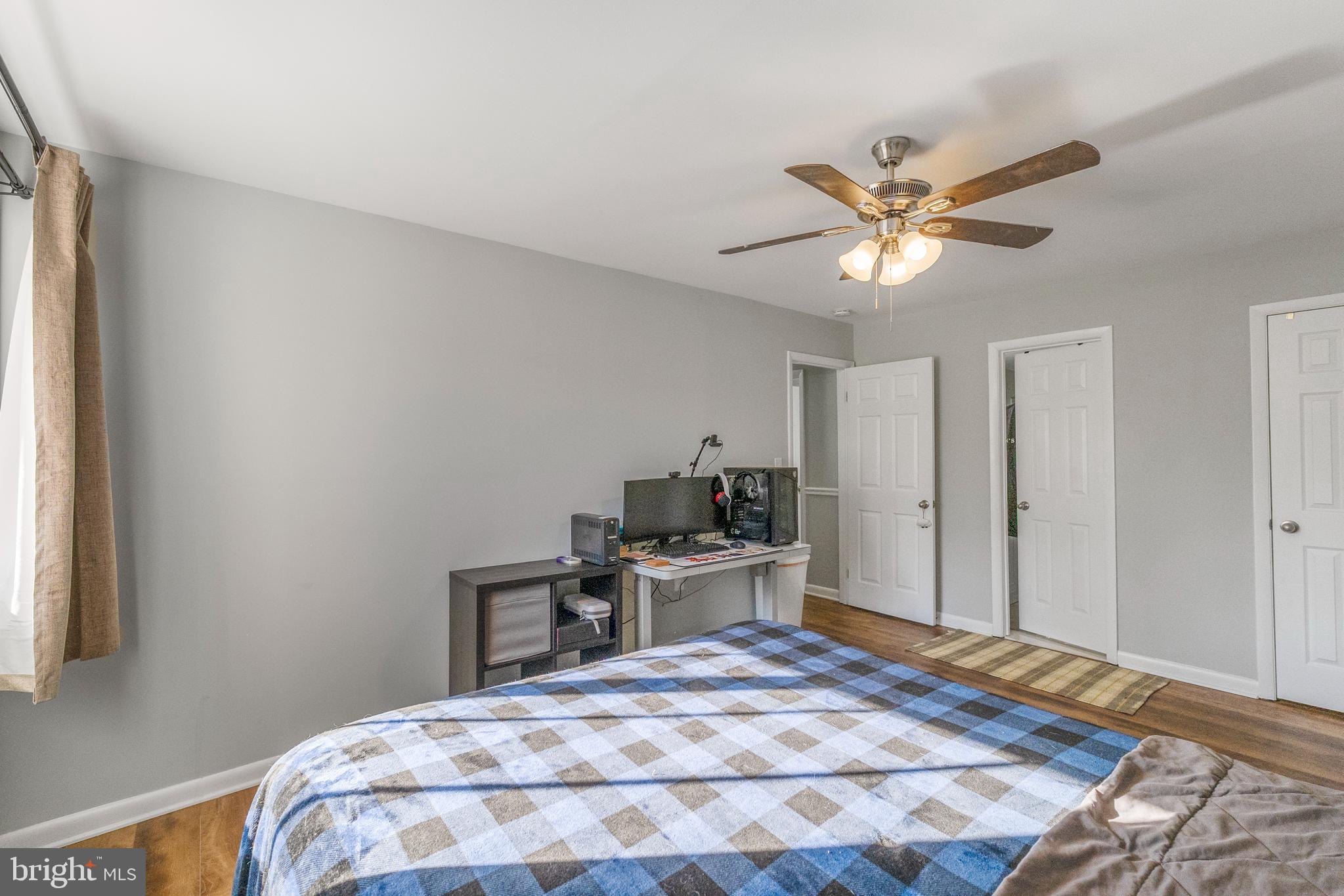 10067 Windstream Drive, Unit 2 Columbia, MD 21044 - Photo 16 of 30 a bedroom with a bed and a chandelier