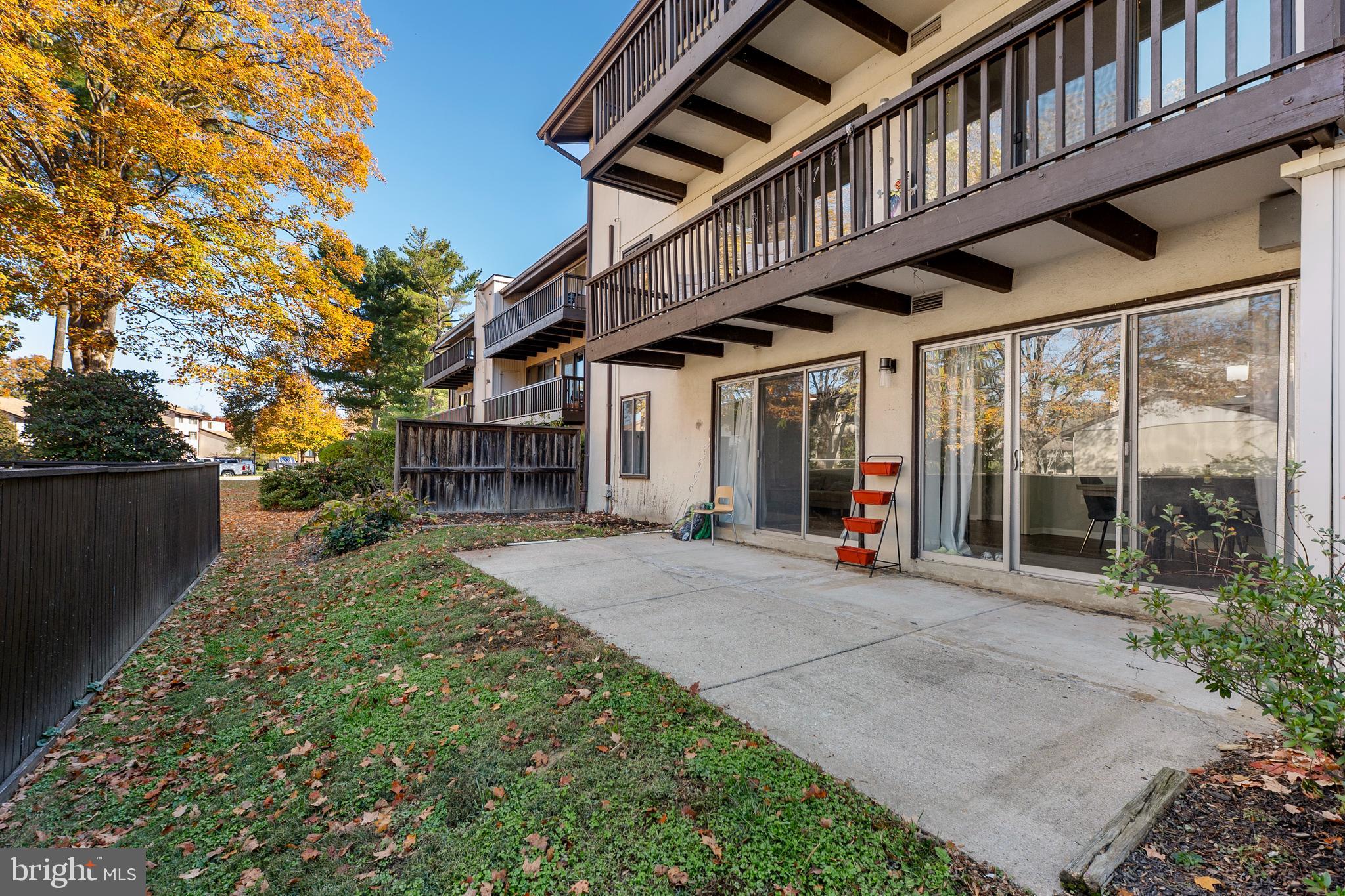 10067 Windstream Drive, Unit 2 Columbia, MD 21044 - Photo 24 of 30 a view of a house with large windows and plants