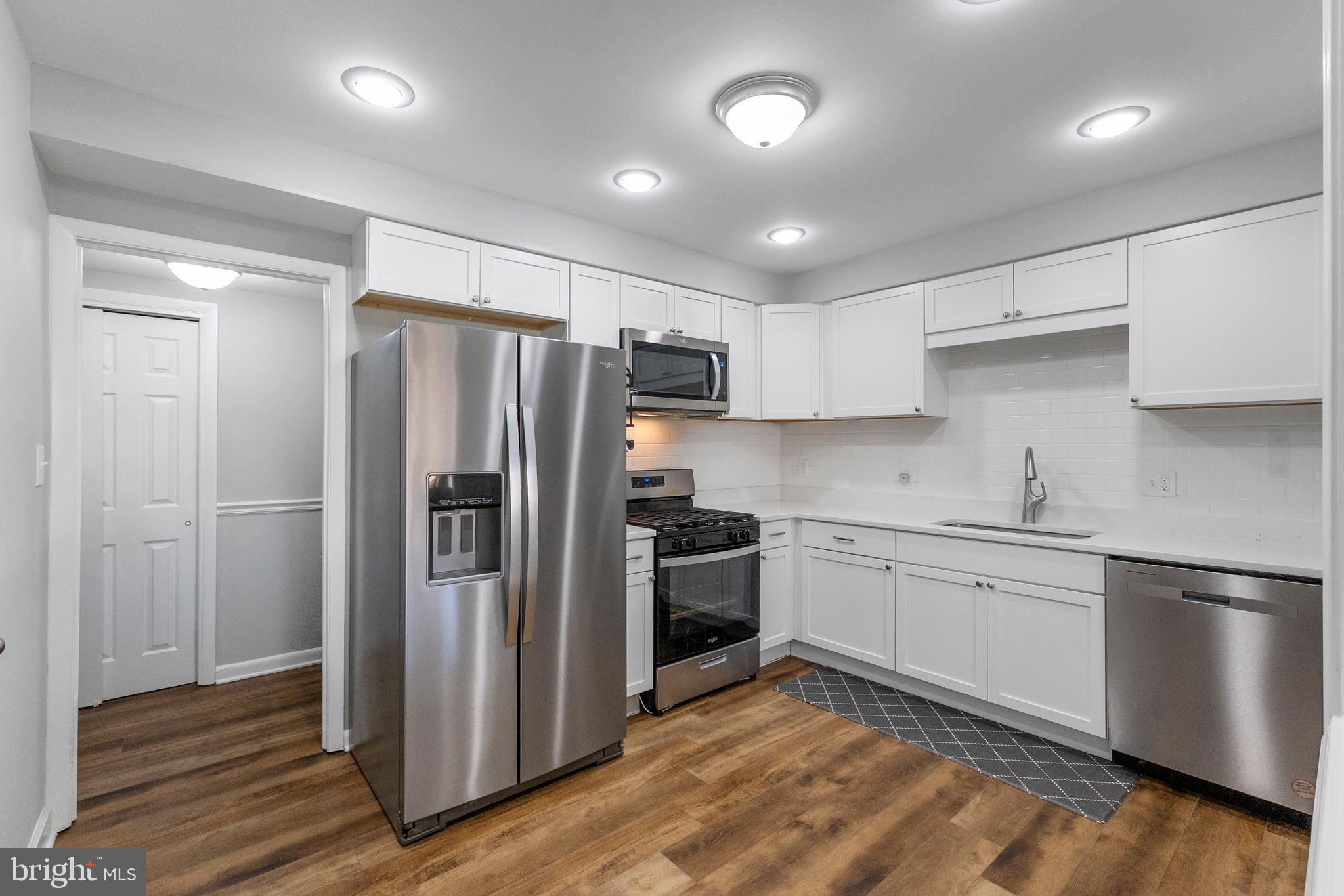10067 Windstream Drive, Unit 2 Columbia, MD 21044 - Photo 4 of 30 a kitchen with stainless steel appliances granite countertop a refrigerator and a stove top oven