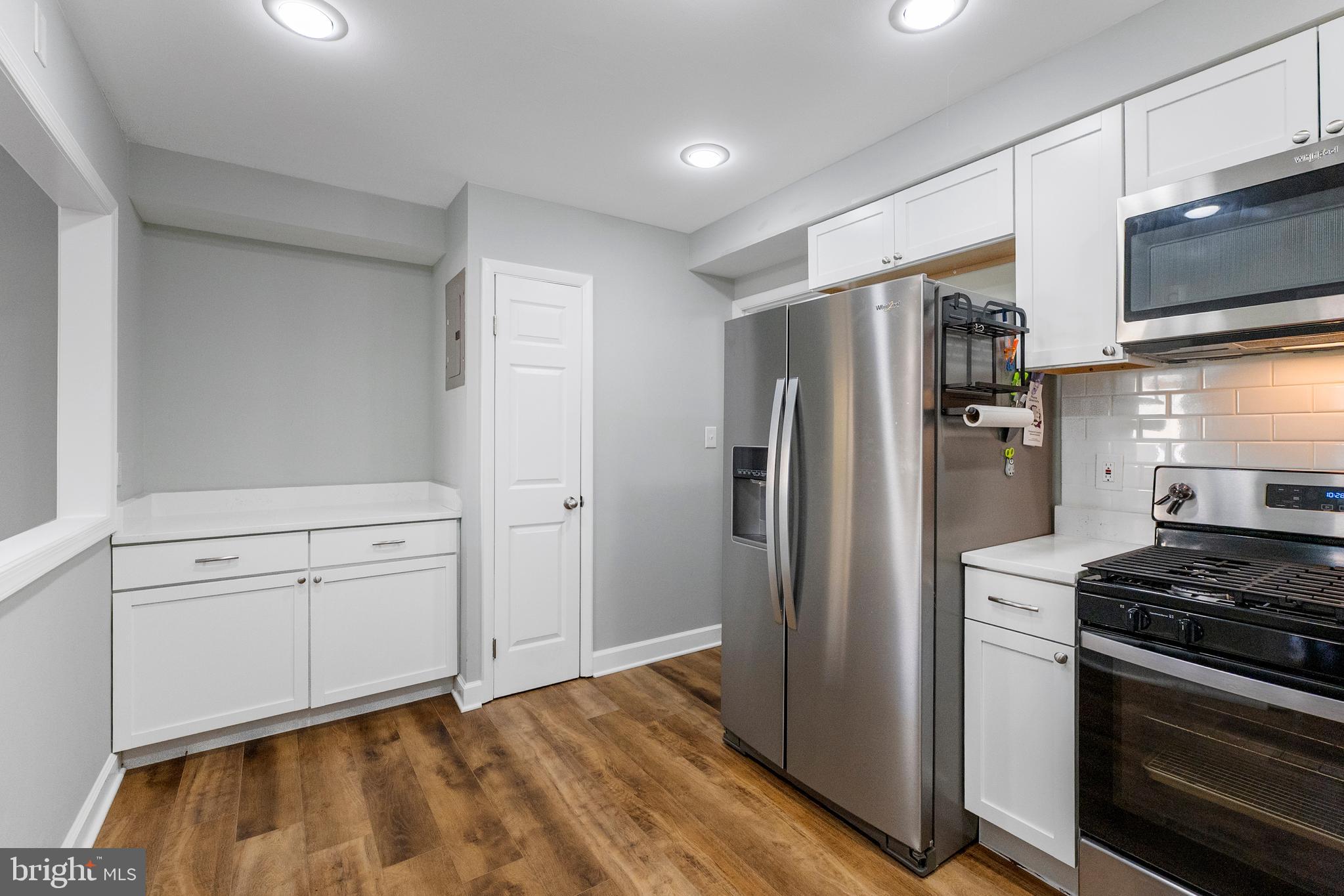 10067 Windstream Drive, Unit 2 Columbia, MD 21044 - Photo 5 of 30 a kitchen with white cabinets and stainless steel appliances