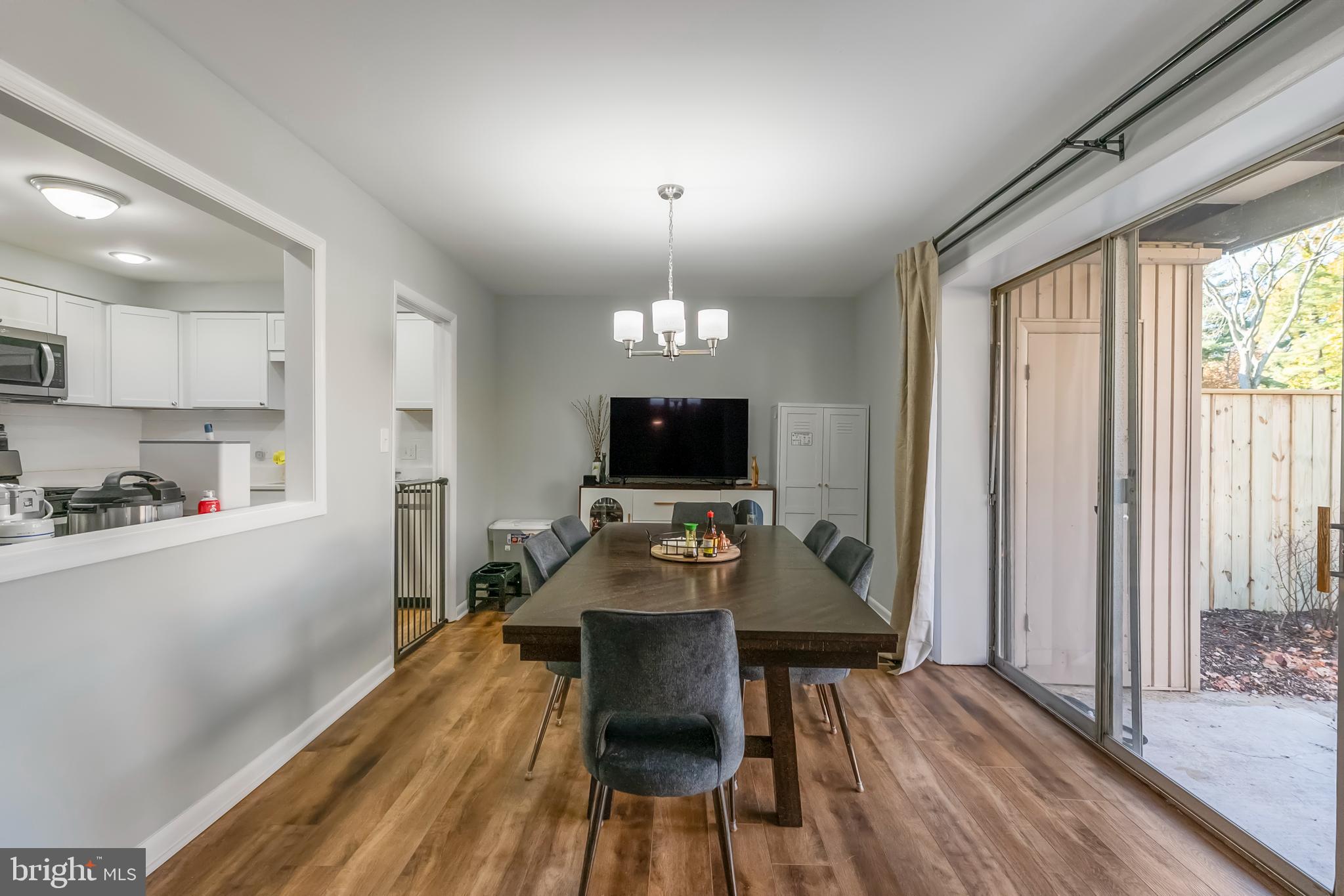 10067 Windstream Drive, Unit 2 Columbia, MD 21044 - Photo 7 of 30 a view of a dining room with furniture window and wooden floor