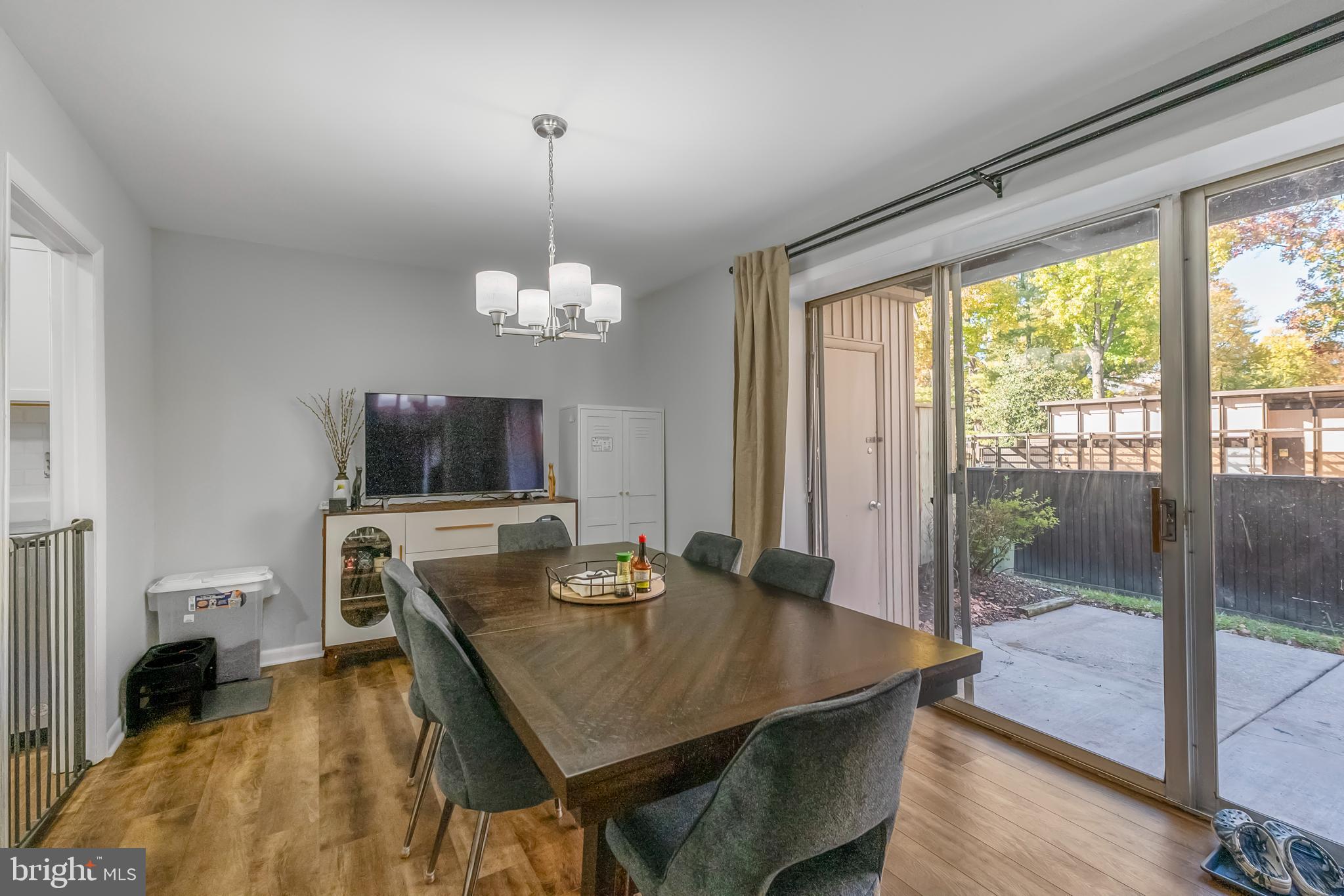 10067 Windstream Drive, Unit 2 Columbia, MD 21044 - Photo 8 of 30 a living room with furniture a table and a flat screen tv