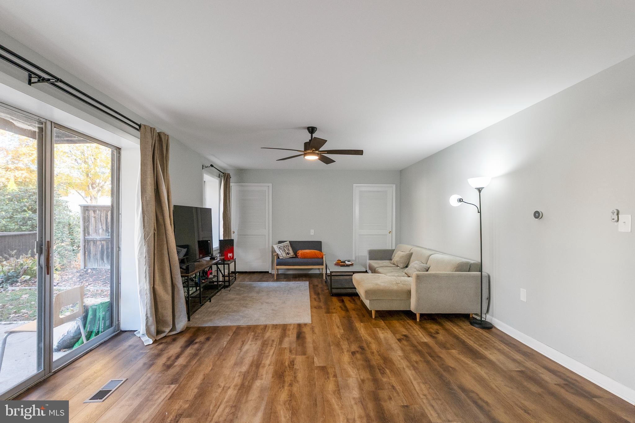 10067 Windstream Drive, Unit 2 Columbia, MD 21044 - Photo 10 of 30 a living room with furniture and a flat screen tv