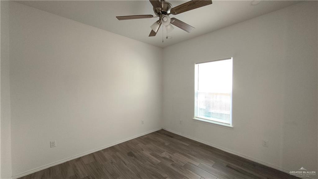 941 South Indiana Avenue, Unit B Mercedes, TX 78570 - Photo 11 of 16 an empty room with a window and a fan