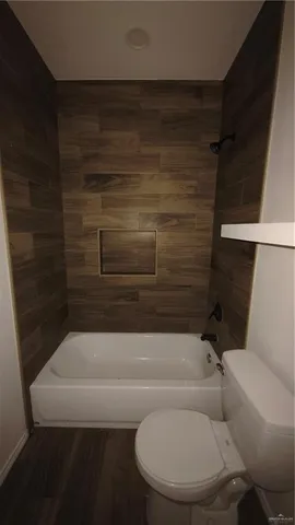 a bathroom with a toilet and bathtub