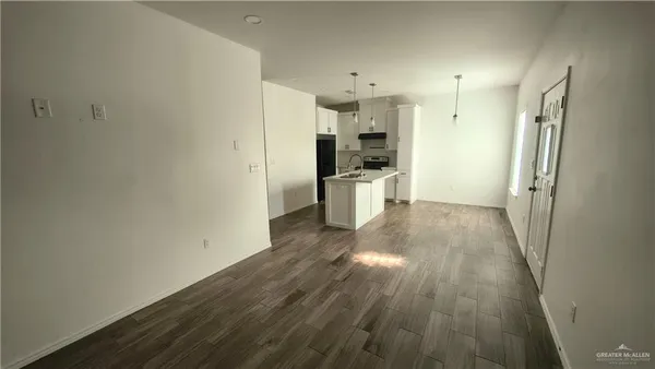 a view of a kitchen with wooden floor