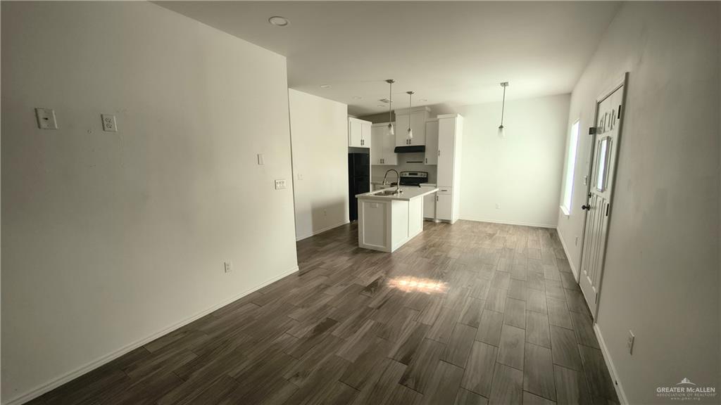 941 South Indiana Avenue, Unit B Mercedes, TX 78570 - Photo 5 of 16 a view of a kitchen with wooden floor