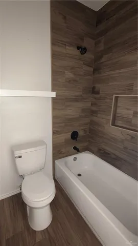 a bathroom with a toilet and a bathtub