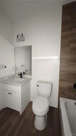 a bathroom with a toilet a sink and bathtub