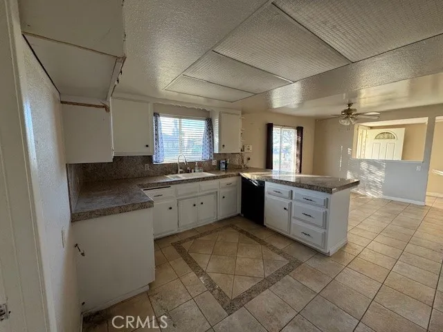 a large kitchen with a stove a sink dishwasher and a refrigerator