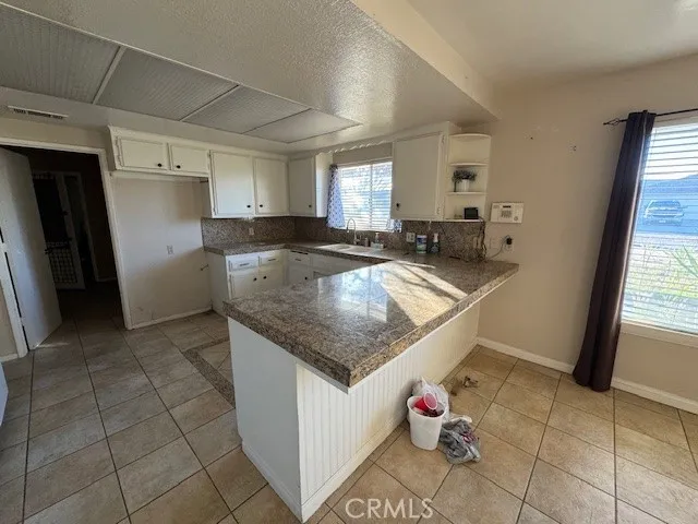 a kitchen with stainless steel appliances granite countertop a sink and dishwasher