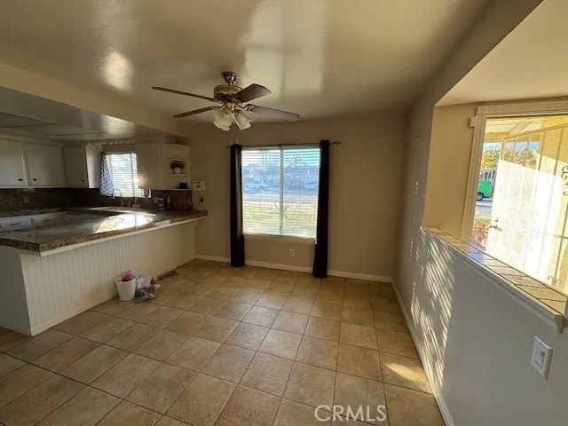 a kitchen with a sink a stove cabinets and a window