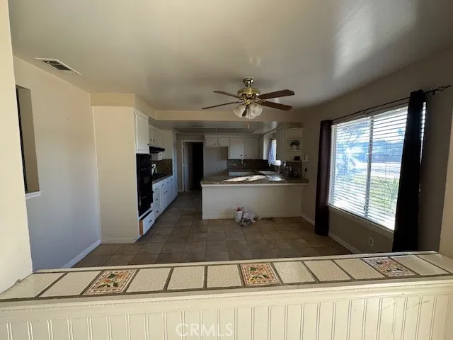 a kitchen with stainless steel appliances kitchen island granite countertop a refrigerator and a sink