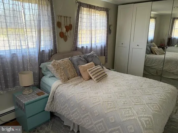 a view of a room with wooden floor and bathroom