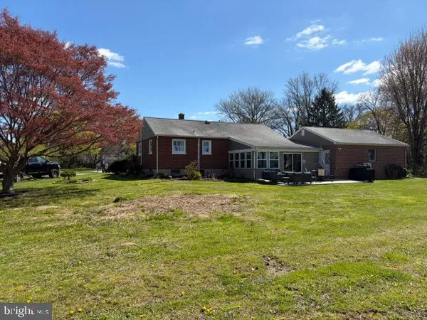 a view of a house with swimming pool and a yard