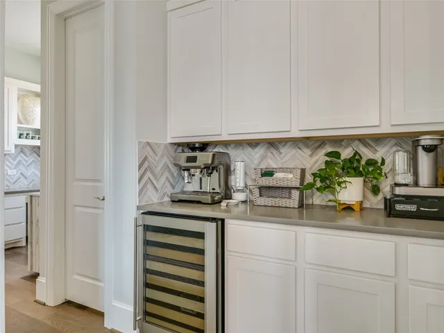 a kitchen with white cabinets and a sink
