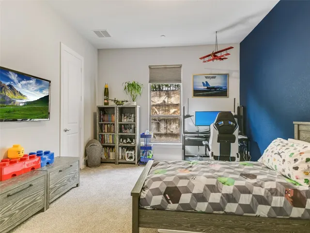 a bedroom with a bed and dresser