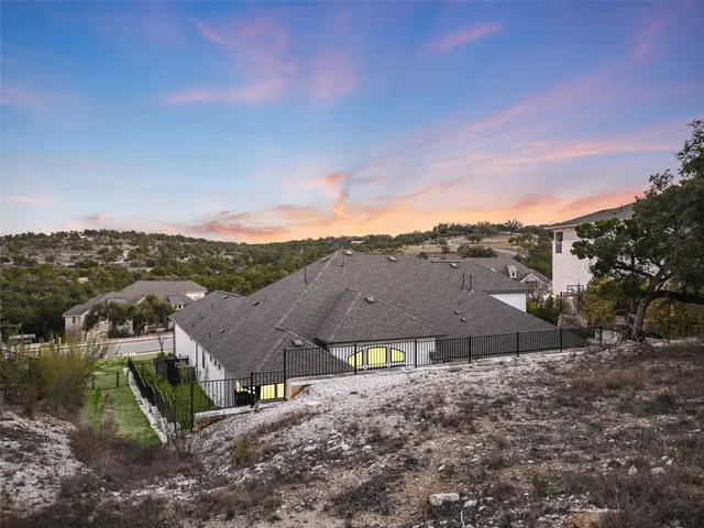 an aerial view of residential houses with outdoor space and street view