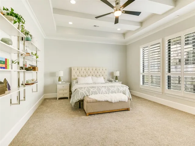 a spacious bedroom with a bed and a large window