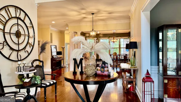 a view of a dining room with furniture and a chandelier