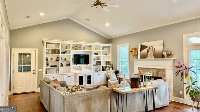 a living room with fireplace furniture and a flat screen tv