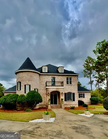 a front view of a house with a yard and potted plants