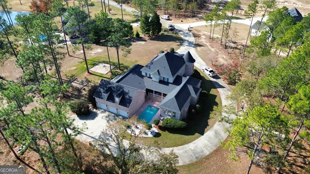 an aerial view of a house with outdoor space and lake view