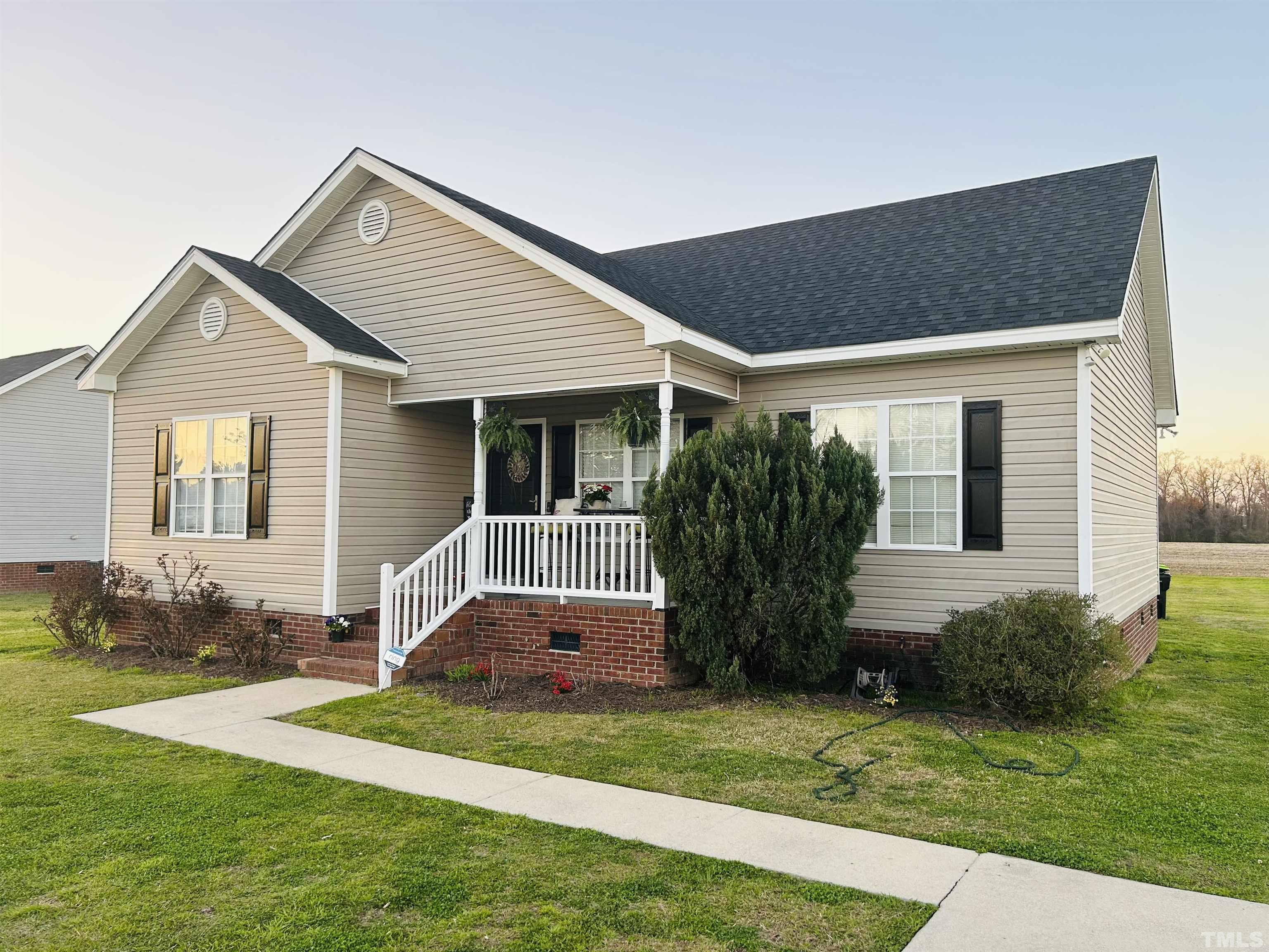 a front view of house with yard and green space