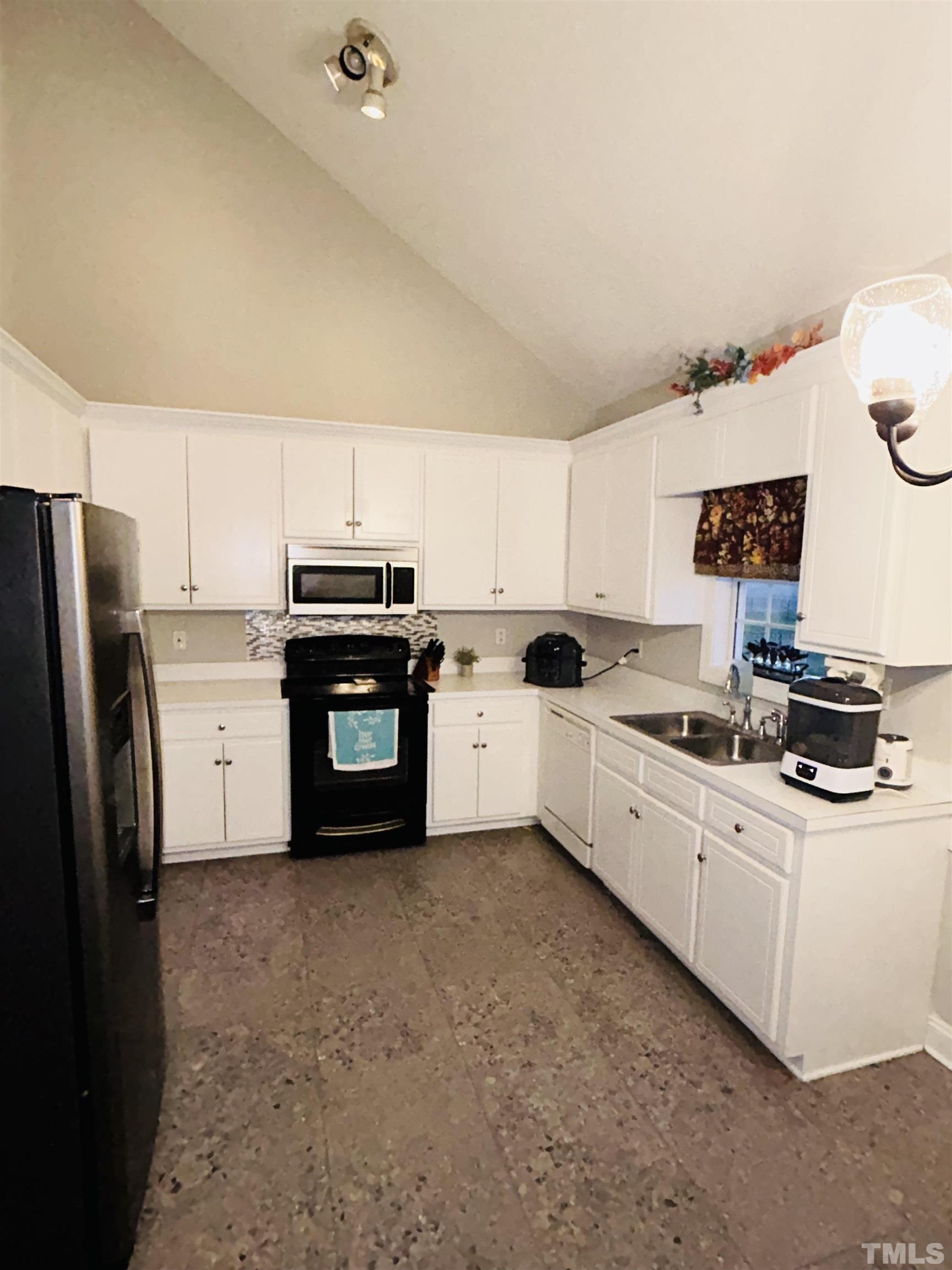 5524 Scuppernong Road Wilson, NC 27893 - Photo 19 of 37 a kitchen with stainless steel appliances granite countertop a stove and a refrigerator