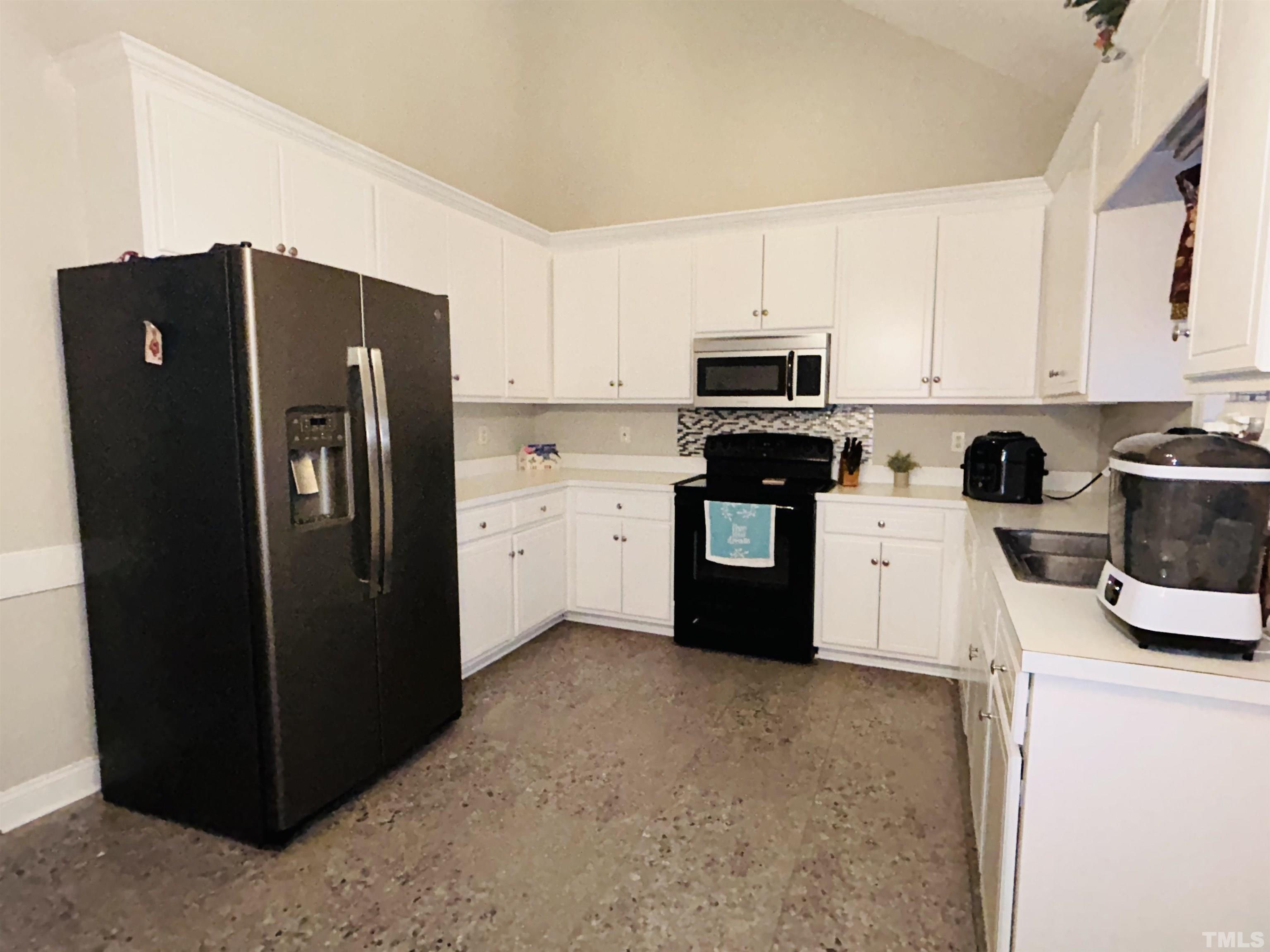 5524 Scuppernong Road Wilson, NC 27893 - Photo 20 of 37 a kitchen with stainless steel appliances granite countertop a refrigerator stove and sink