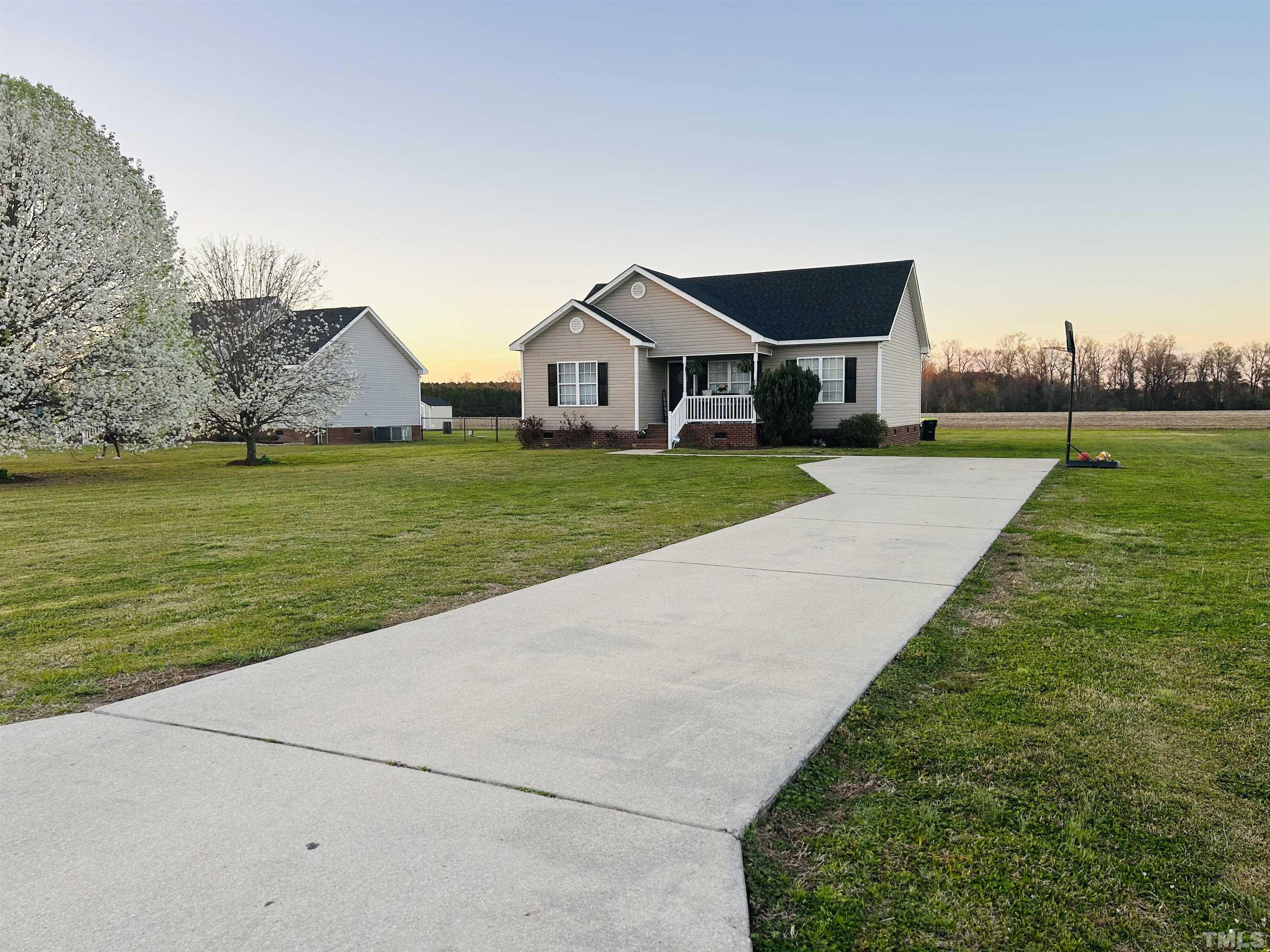 5524 Scuppernong Road Wilson, NC 27893 - Photo 2 of 37 a front view of a house with a yard and lake