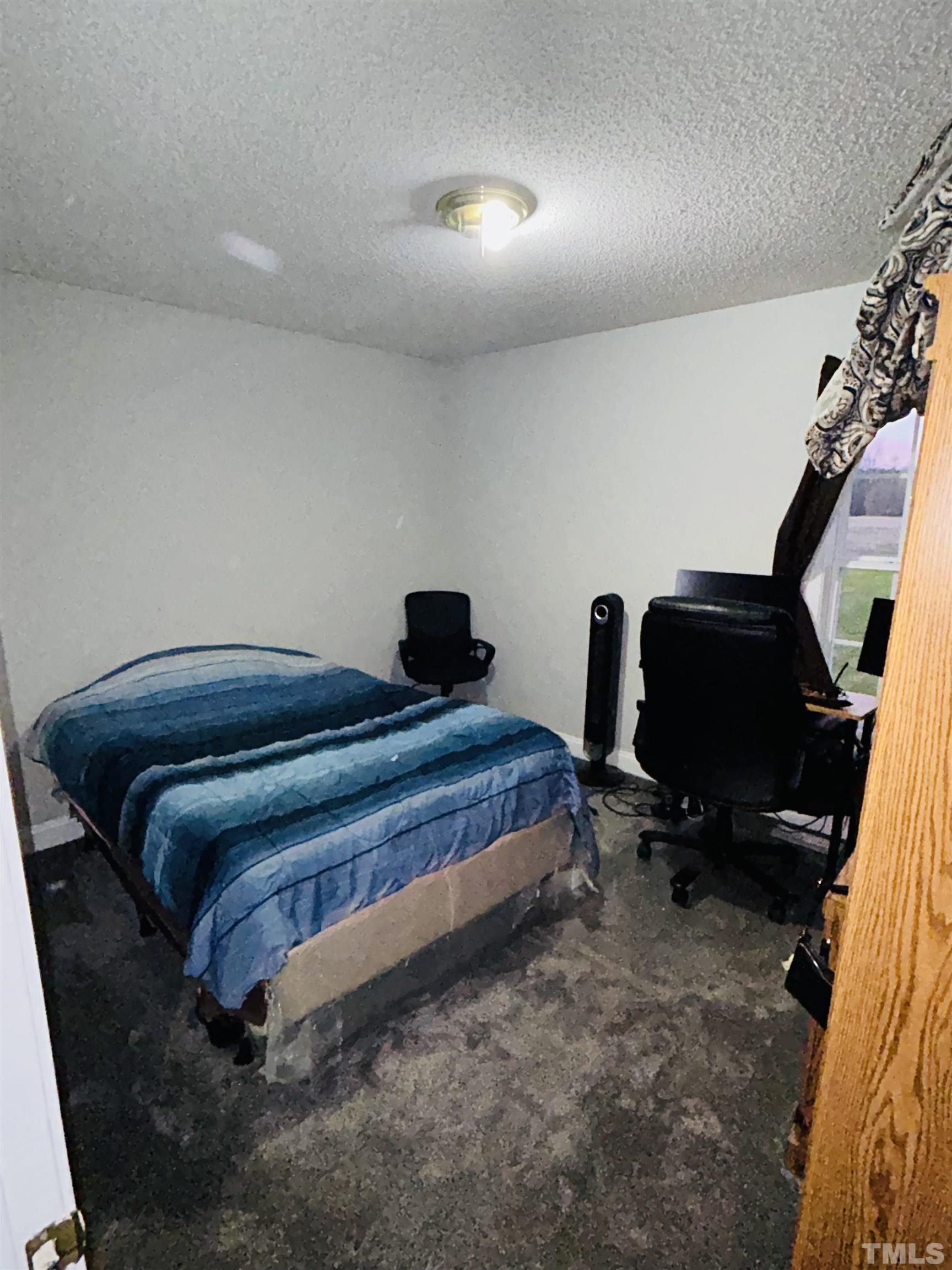 5524 Scuppernong Road Wilson, NC 27893 - Photo 23 of 37 a bedroom with a bed and gym equipment