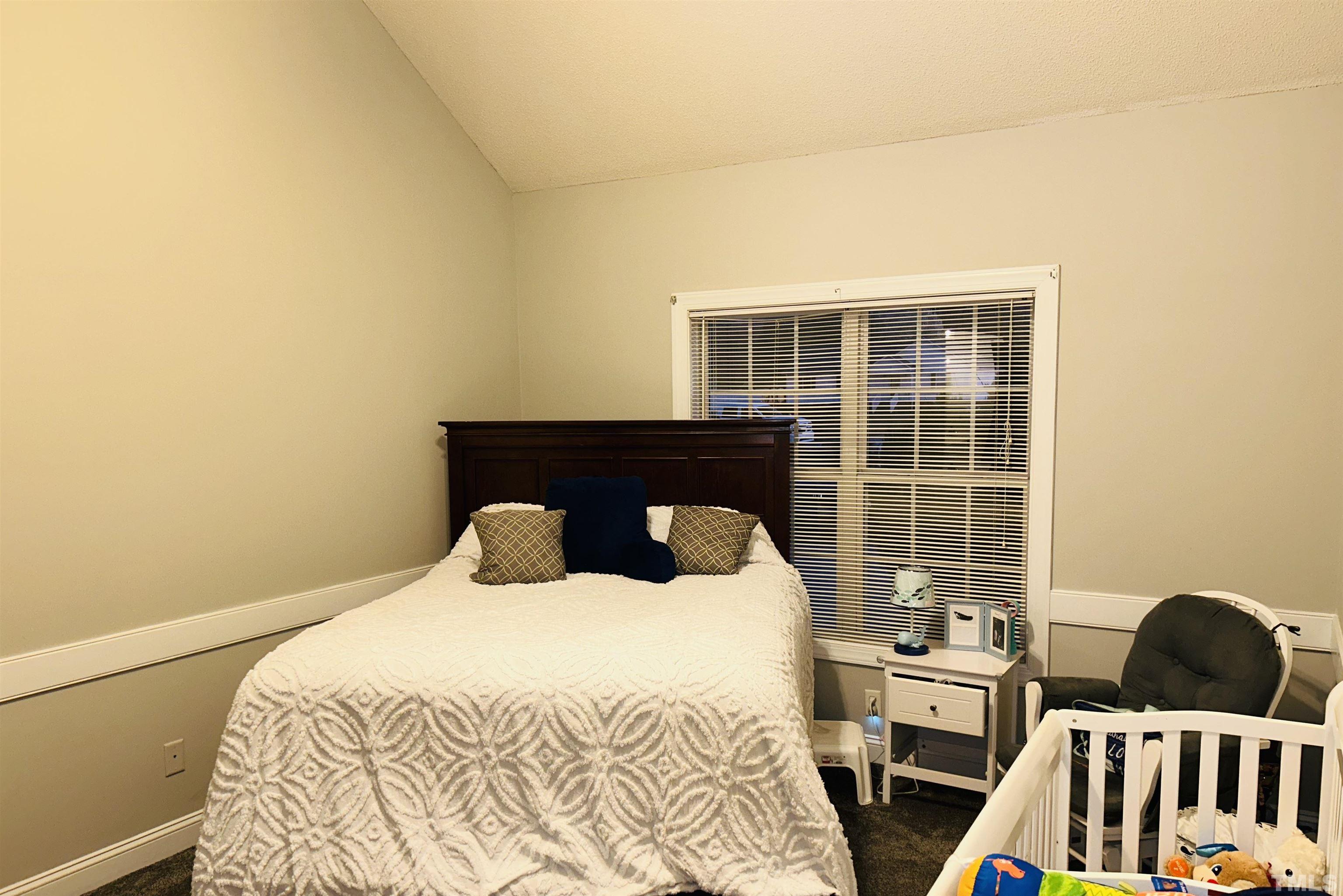 5524 Scuppernong Road Wilson, NC 27893 - Photo 33 of 37 a bedroom with a bed and wooden floor