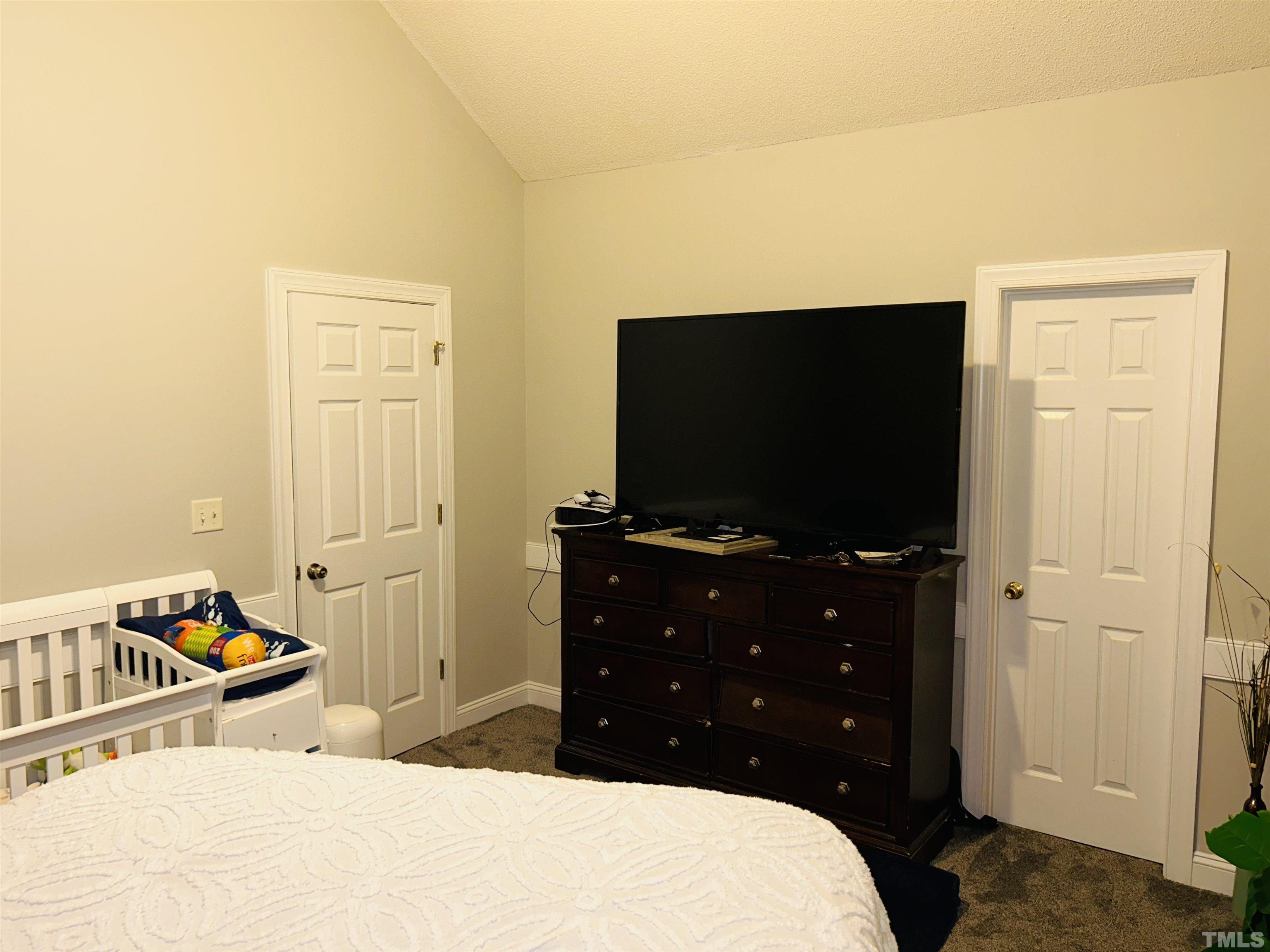 5524 Scuppernong Road Wilson, NC 27893 - Photo 34 of 37 a bedroom with a bed and a flat screen tv