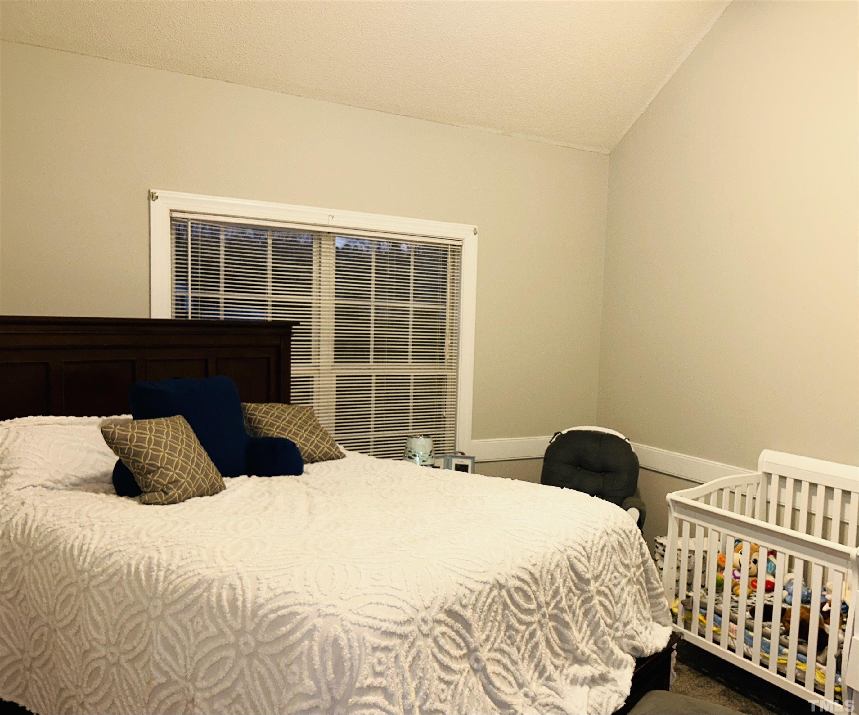 5524 Scuppernong Road Wilson, NC 27893 - Photo 35 of 37 a bedroom with a bed and a window