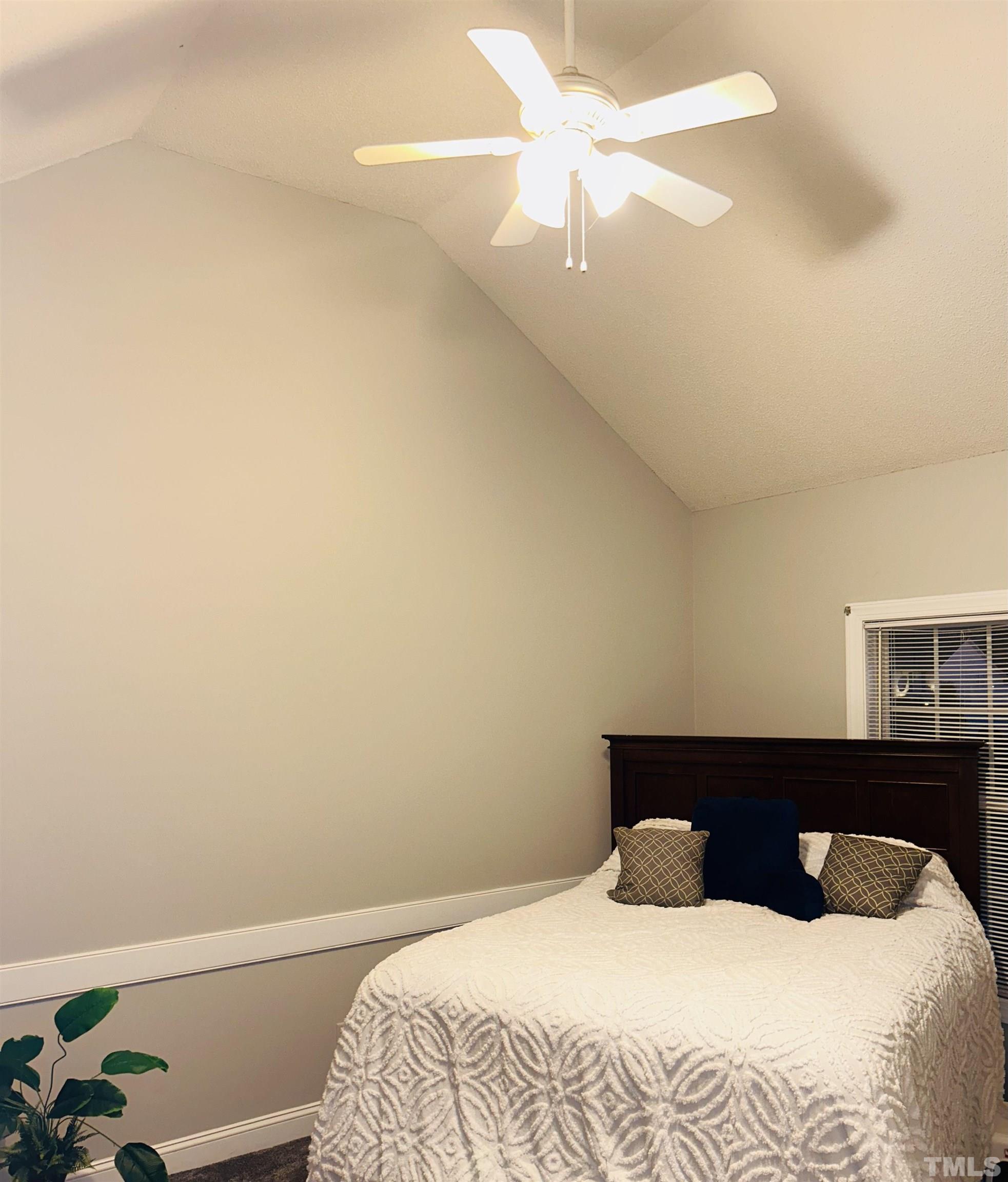 5524 Scuppernong Road Wilson, NC 27893 - Photo 37 of 37 a bedroom with a bed and a chandelier