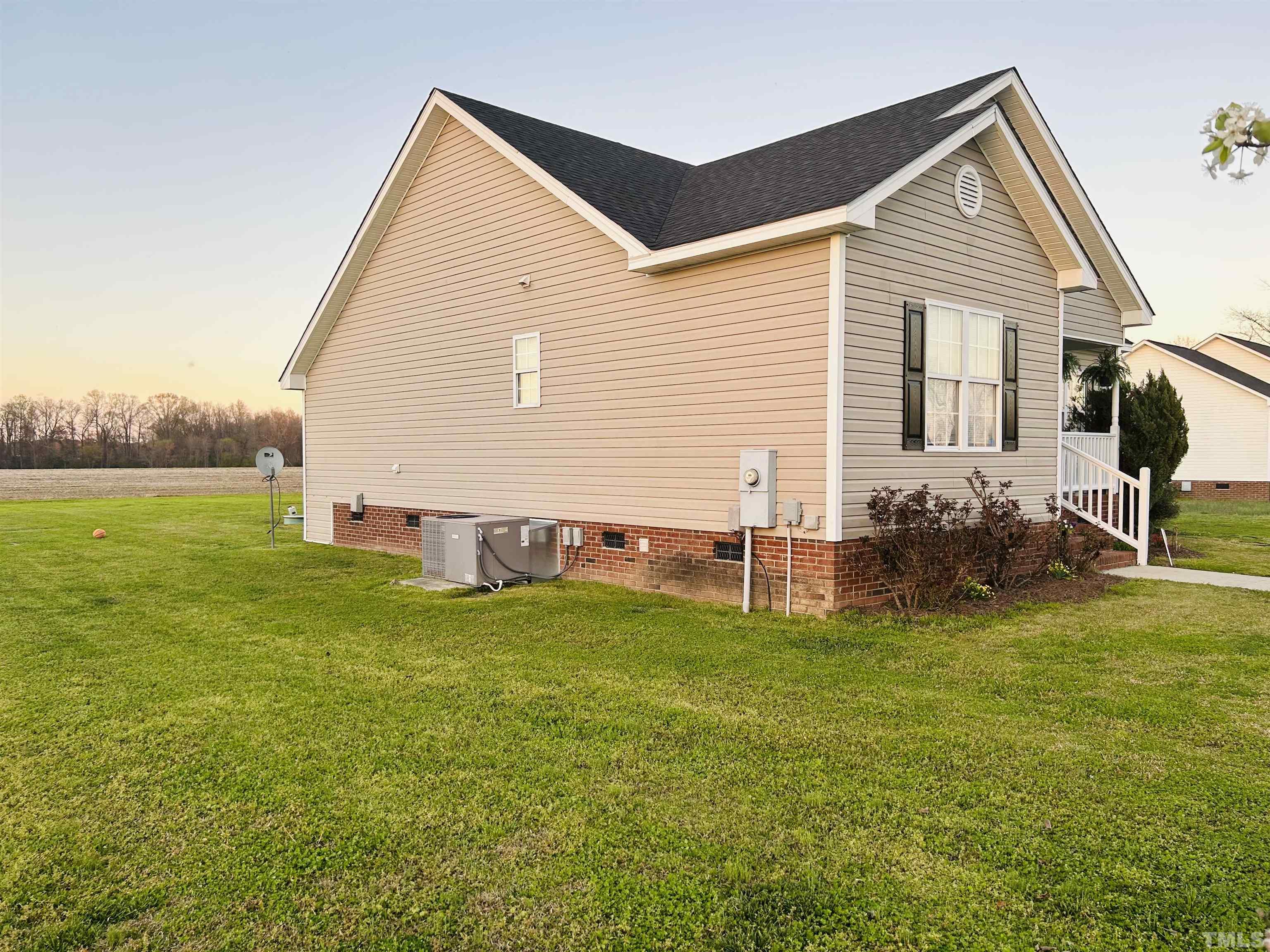 5524 Scuppernong Road Wilson, NC 27893 - Photo 6 of 37 a view of a house with a yard and a garden