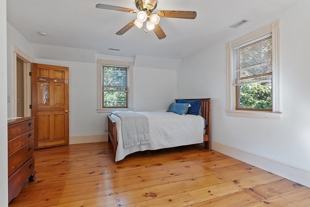 161 Haggetts Pond Road Andover, MA 01810 - Photo 13 of 34 a bedroom with a bed and wooden floor
