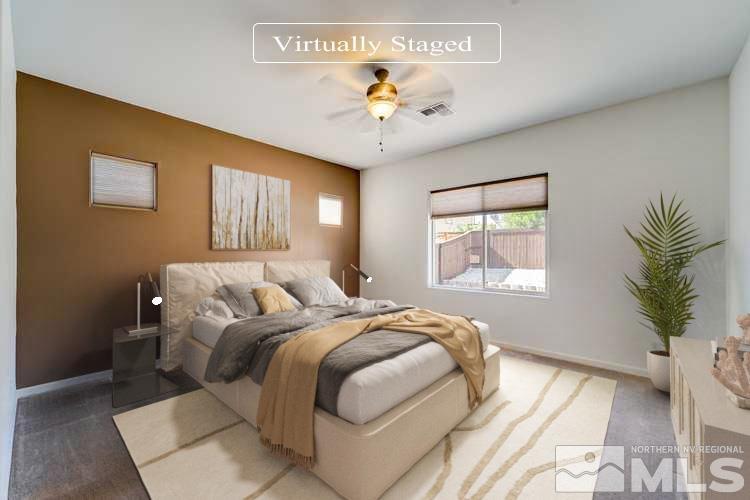 2845 Bonfire Lane Reno, NV 89521 - Photo 3 of 26 a bedroom with a large bed and a chandelier