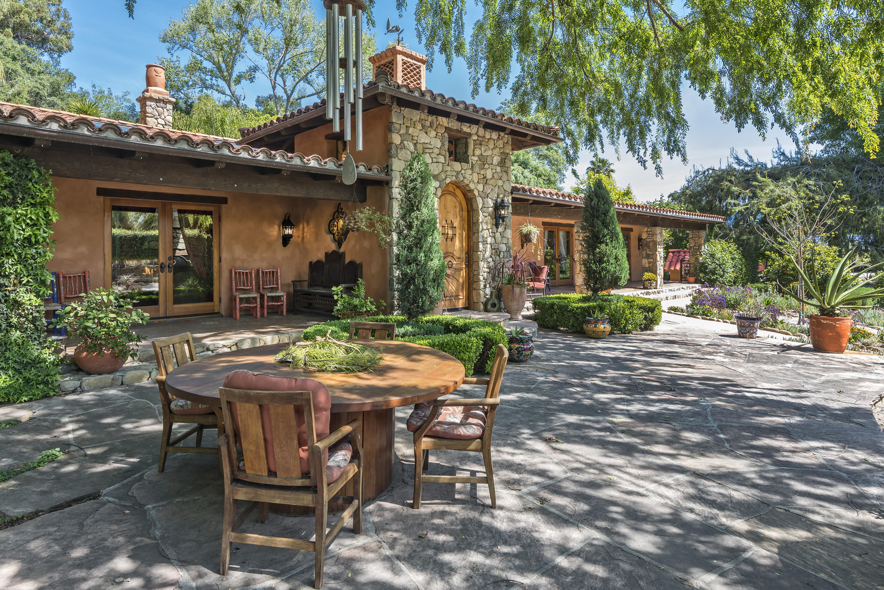 129 Grapevine Road Oak View, CA 93022 - Photo 3 of 24 a view of a patio with table and chairs and potted plants