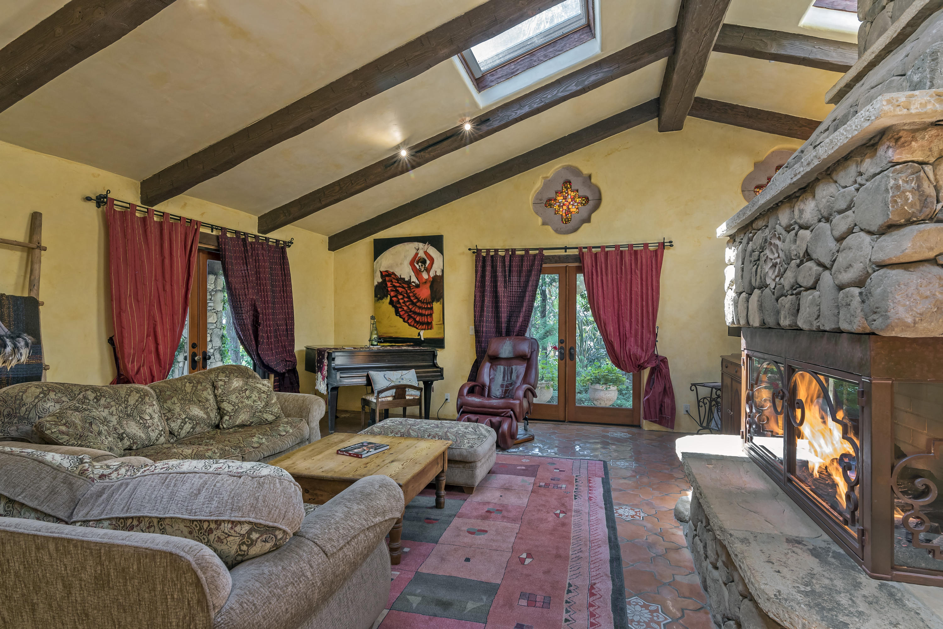 129 Grapevine Road Oak View, CA 93022 - Photo 8 of 24 a living room with furniture a flat screen tv and a fireplace