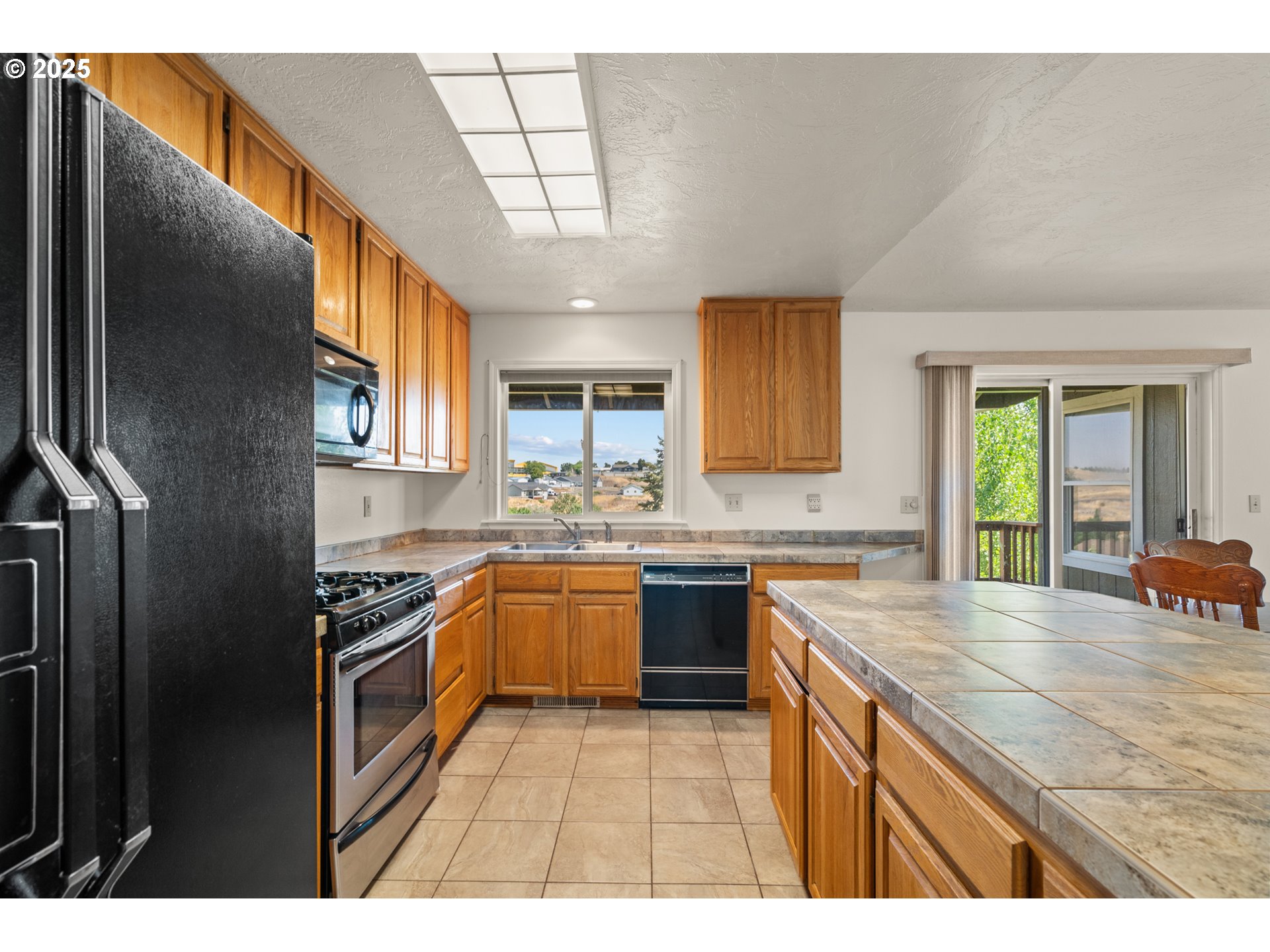 1837 Southwest Athens Avenue Pendleton, OR 97801 - Photo 14 of 42 a kitchen with stainless steel appliances granite countertop a sink stove and refrigerator
