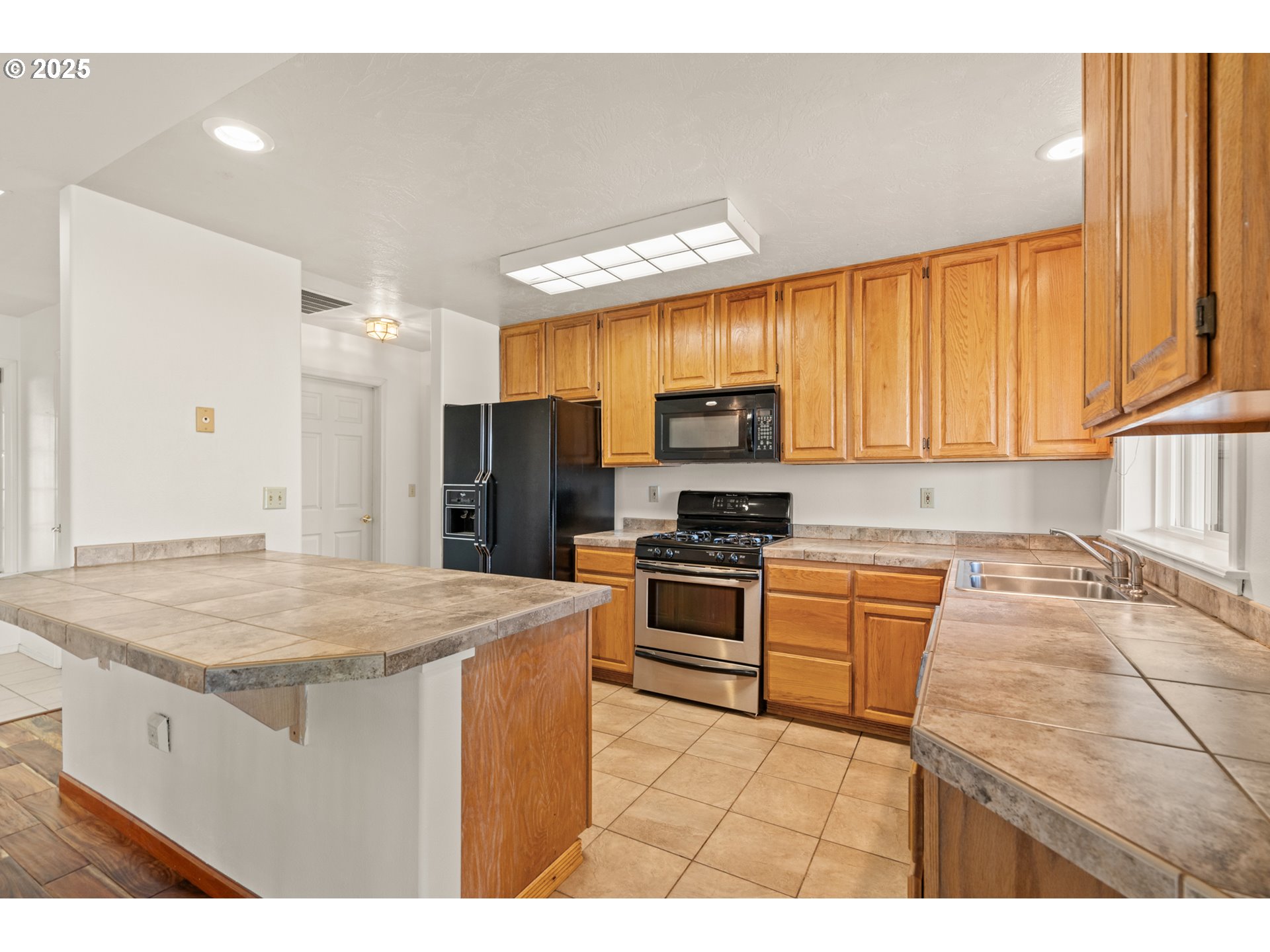 1837 Southwest Athens Avenue Pendleton, OR 97801 - Photo 16 of 42 a kitchen with stainless steel appliances granite countertop a sink stove and refrigerator
