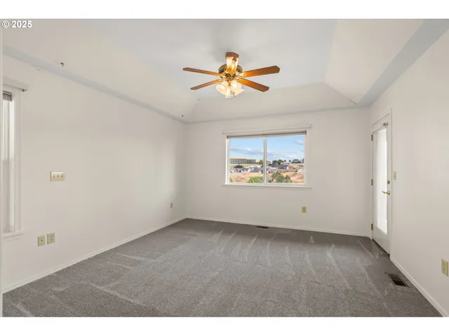 a view of room with a ceiling fan and a window
